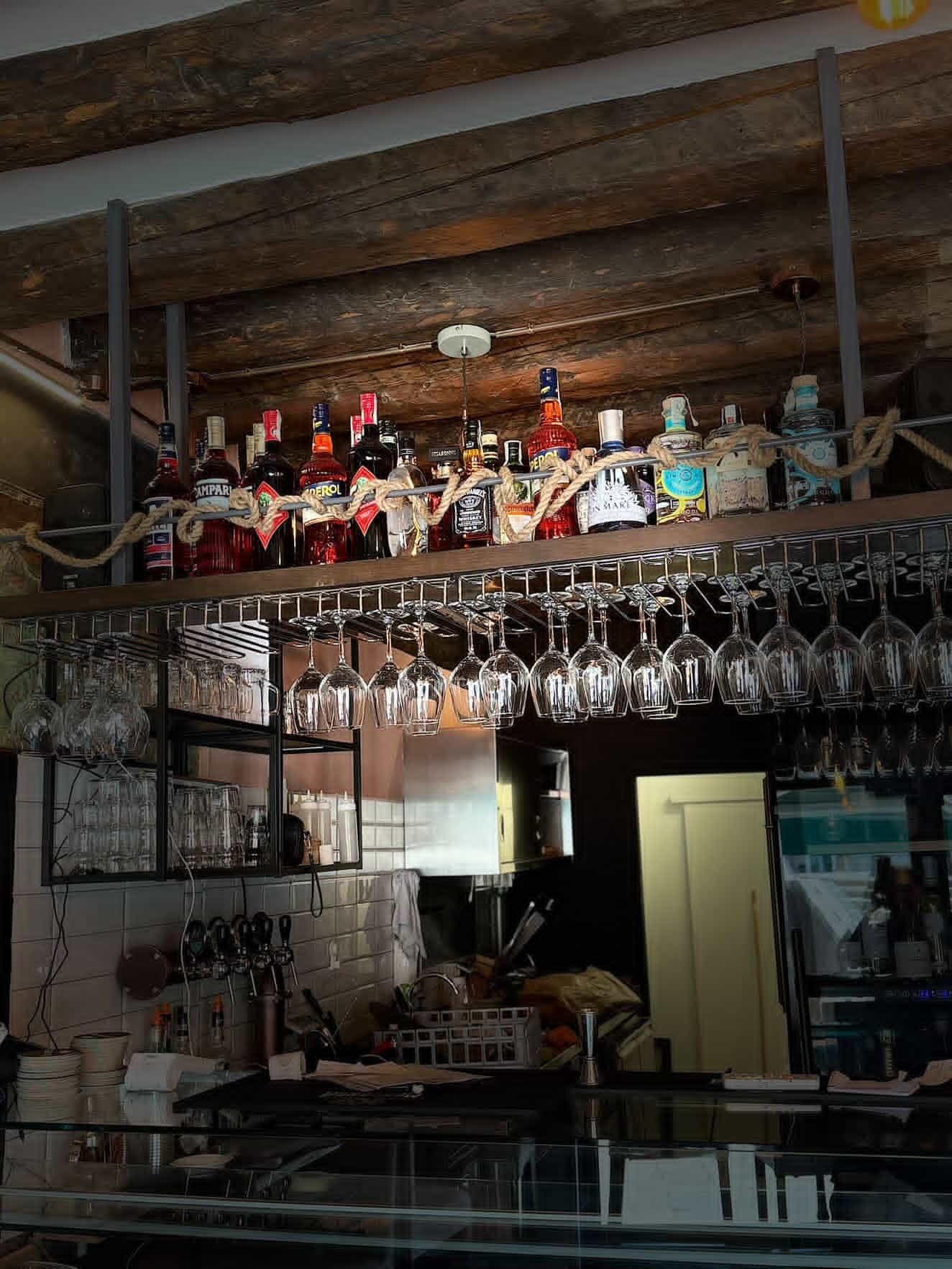 Spirits and hanging glasses behind the bar