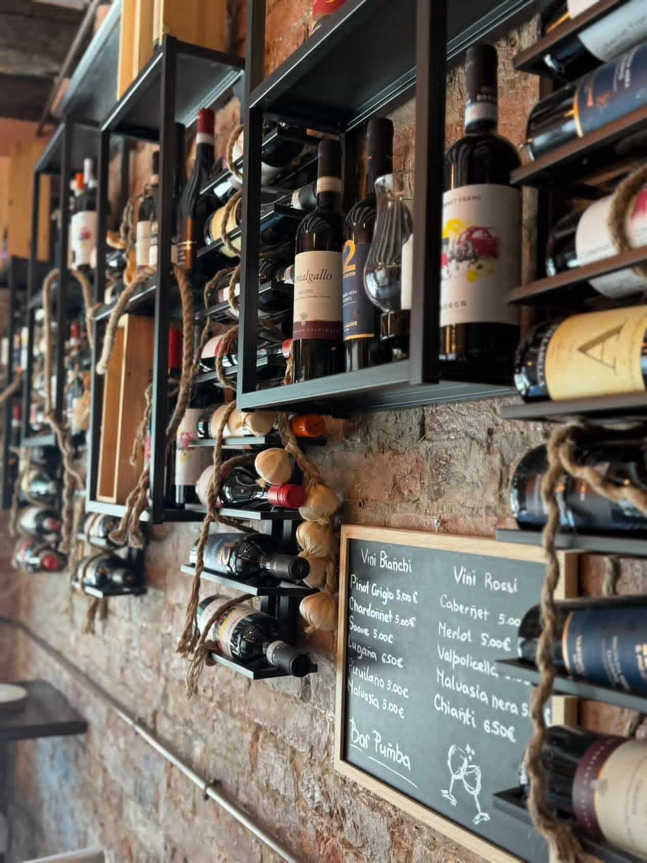 Wall of Italian wines with the day's chalkboard list
